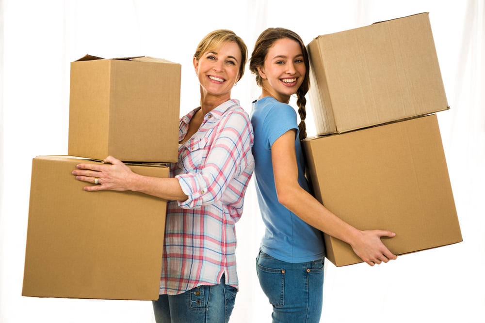 Mother and daughter holding boxes and smiling